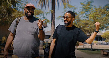 Two men walking happily